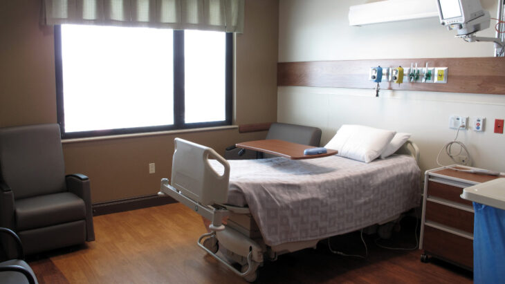 Inside of a hospital room with a bed, where someone might undergo medical detox