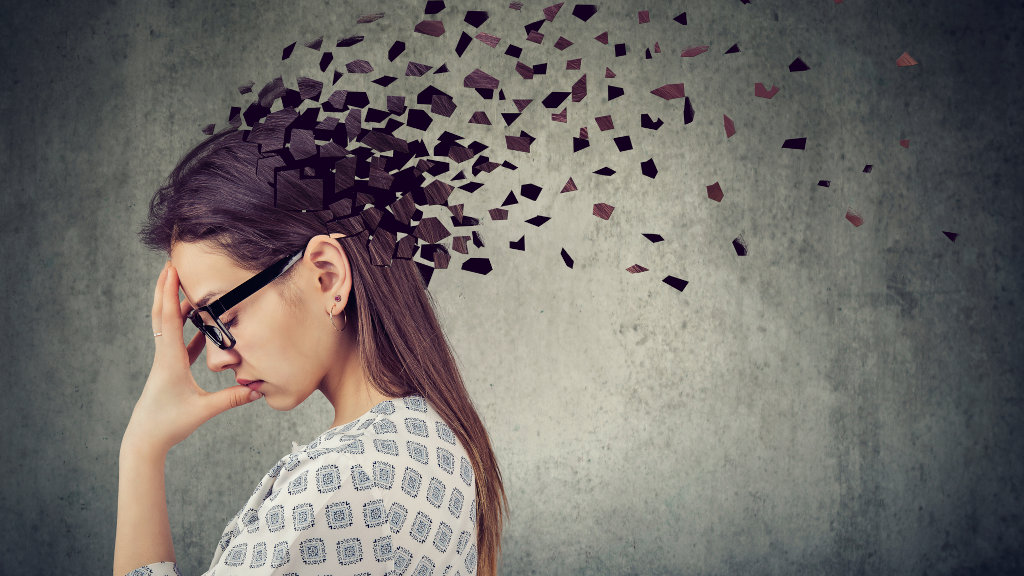 A woman clutches her head in an artistic representation of memory loss