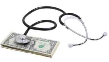 a stethoscope with a stack of dollars