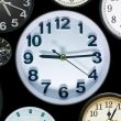 A stock photo with a half dozen clocks pointed towards various times