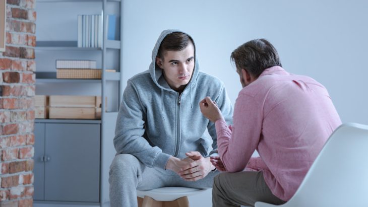 A man speaks with a doctor during an appointment