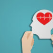 A mock-up of a head with a cartoon heart in it, representing mental health or wellness