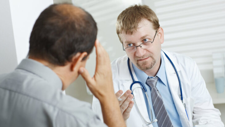 A doctor discusses dual diagnosis with a patient during an appointment