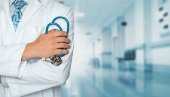 A doctor holding a stethoscope inside a hospital. find top centers for marijuana rehab near you