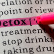 A highlighter marking the word "Detox" in a dictionary. learn more about what detox is here.
