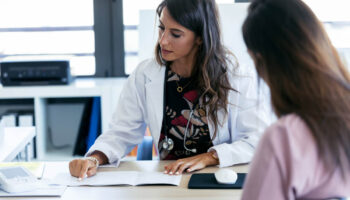 A woman speaking with a doctor. Learn more about how to create a relapse prevention plan here
