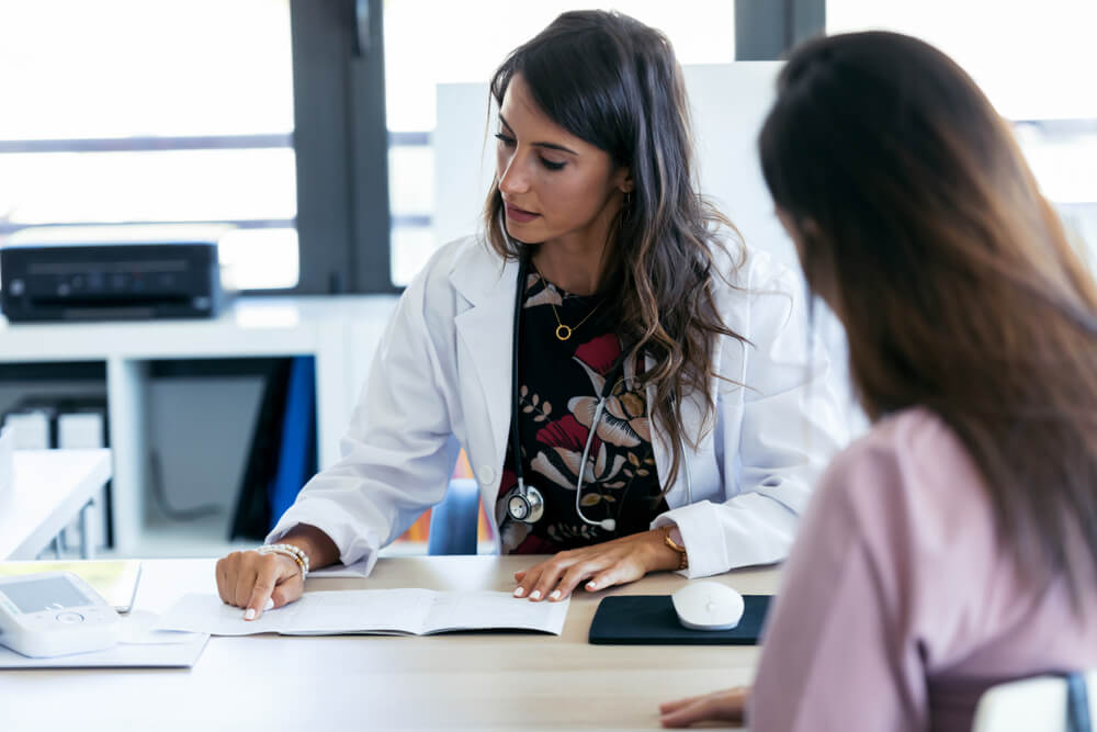 A woman speaking with a doctor. Learn more about how to create a relapse prevention plan here