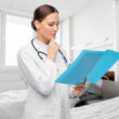 A doctor looks over someone's file. Learn more about suboxone vs methadone here.