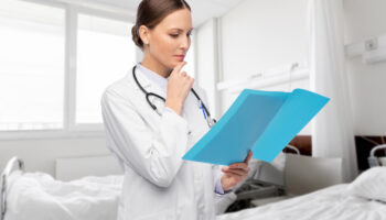 A doctor looks over someone's file. Learn more about suboxone vs methadone here.