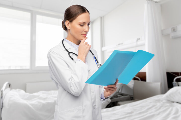 A doctor looks over someone's file. Learn more about suboxone vs methadone here.