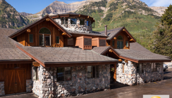Exterior of Cirque Lodge main building showing stone and wood construction with mountain backdrop