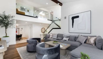 Modern common area at a Calabasas addiction treatment facility, showing plush armchairs, hardwood floors, and a bright, open floor plan.