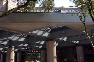 Exterior covered entry structure with pergola and columns at medical facility entrance