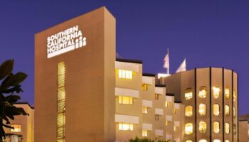 Exterior view of Southern California Hospital building at evening with illuminated windows and entrance signage