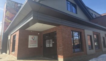 Exterior view of Fair Haven Community Health Center brick building with main entrance, signage, and modern architectural features