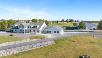 Exterior aerial view of The Aviary Recovery Center showing white main building, grounds, parking areas, and surrounding countryside