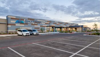 Exterior front facade of Rio Vista Behavioral Health with contemporary striped design, windows, and parking area
