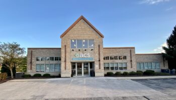 Exterior front view of Affiliated Clinical Services brick building with main entrance, landscaping, and parking area