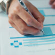 A doctor signing forms for medical insurance. Does Cigna offer detox or rehab coverage? Learn more here.