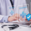 A doctor taps a graphic representing medical insurance. Does Humana cover drug and alcohol detox and rehab? Learn more here.