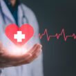 A doctor holding a graphic of a heart with a cross on it. Does Molina healthcare offer rehab and detox coverage? Learn more here.