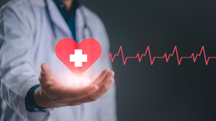 A doctor holding a graphic of a heart with a cross on it. Does Molina healthcare offer rehab and detox coverage? Learn more here.